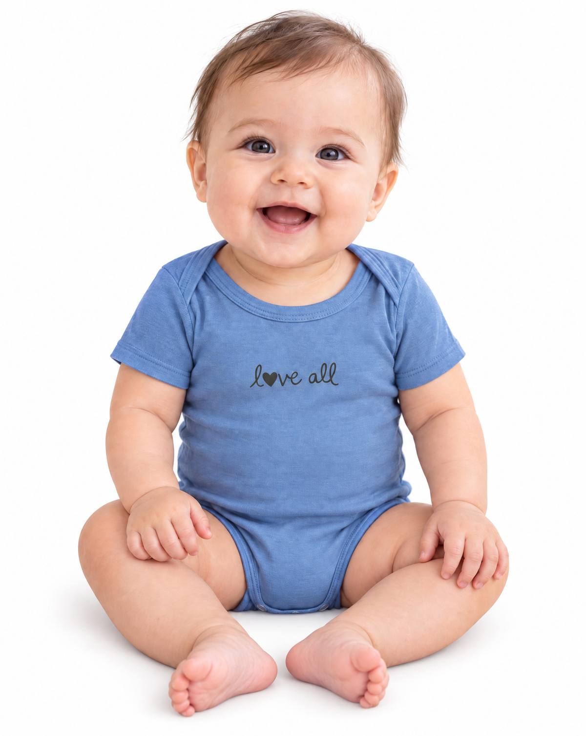 A smiling baby sitting on a white background, wearing a heathered blue short-sleeve bodysuit with 'love all' printed in black script across the chest.