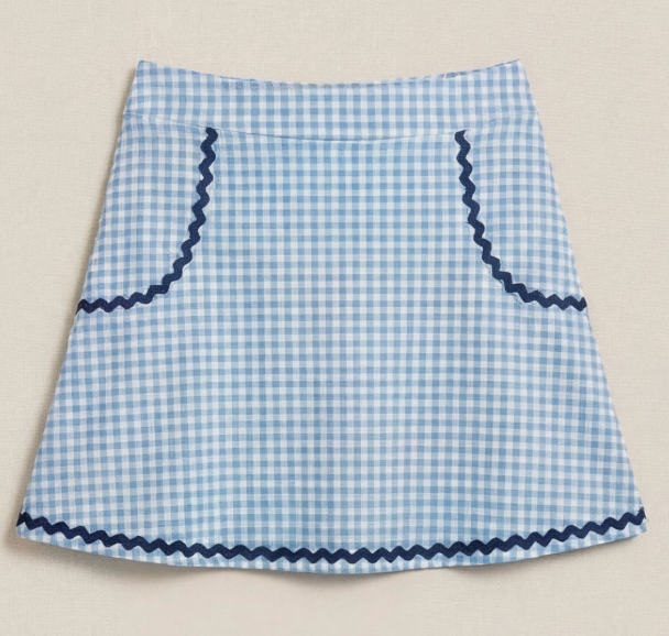 Blue and white checkered apron with navy trim on a beige background