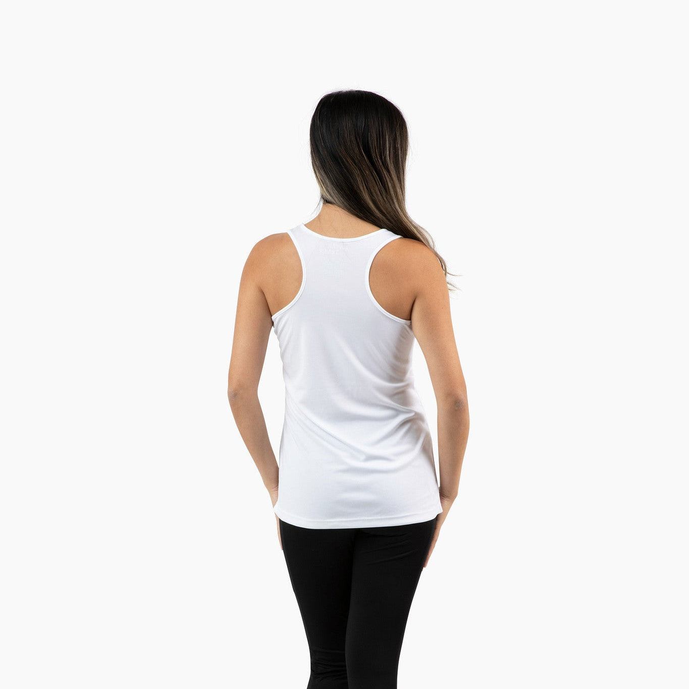 Person wearing a white tank top and black leggings on a white background