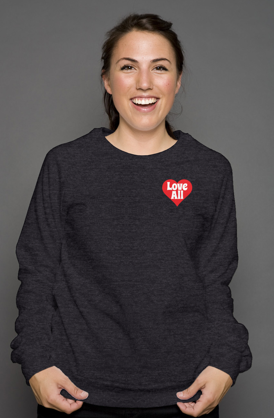Person wearing a dark gray sweatshirt with a red heart design on a gray background