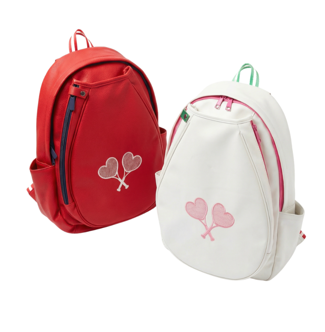 Two small backpacks shown on a plain white background: one red backpack on the left and one white backpack on the right. Each backpack has a front zip pocket, side pockets, top handles, and a heart-shaped embroidery on the front.