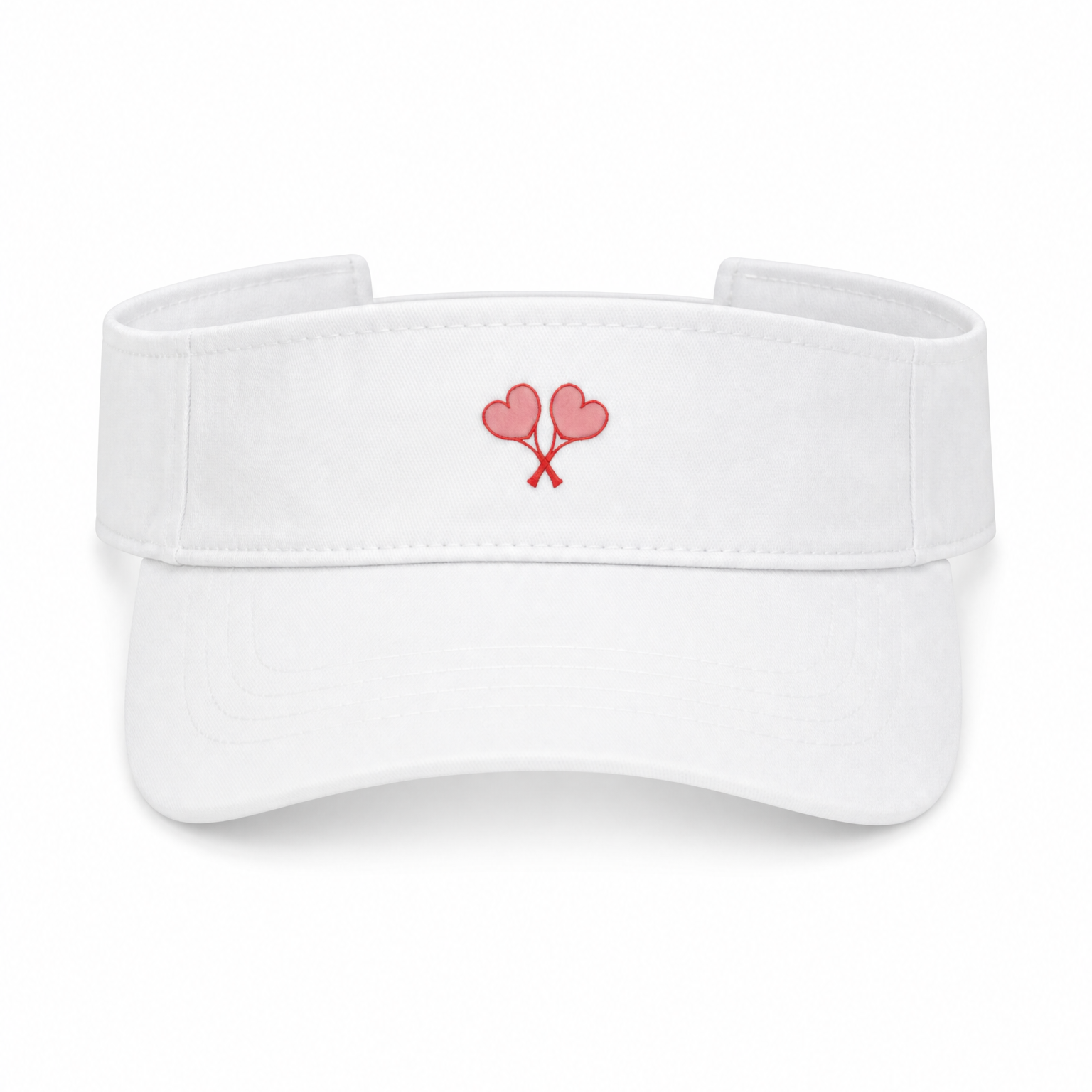 A white visor hat featuring a small embroidered design of two pink heart tennis rackets crossed on the front center, set against a plain white background.