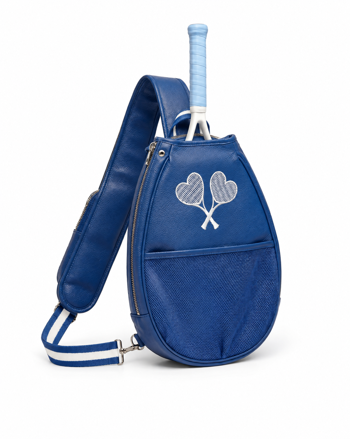 A royal blue tennis bag with a textured front pocket, a white embroidered crossed tennis rackets motif, and a light blue tennis grip tucked into the top opening. The bag features a wide shoulder strap with white stripes and is photographed on a clean white background.