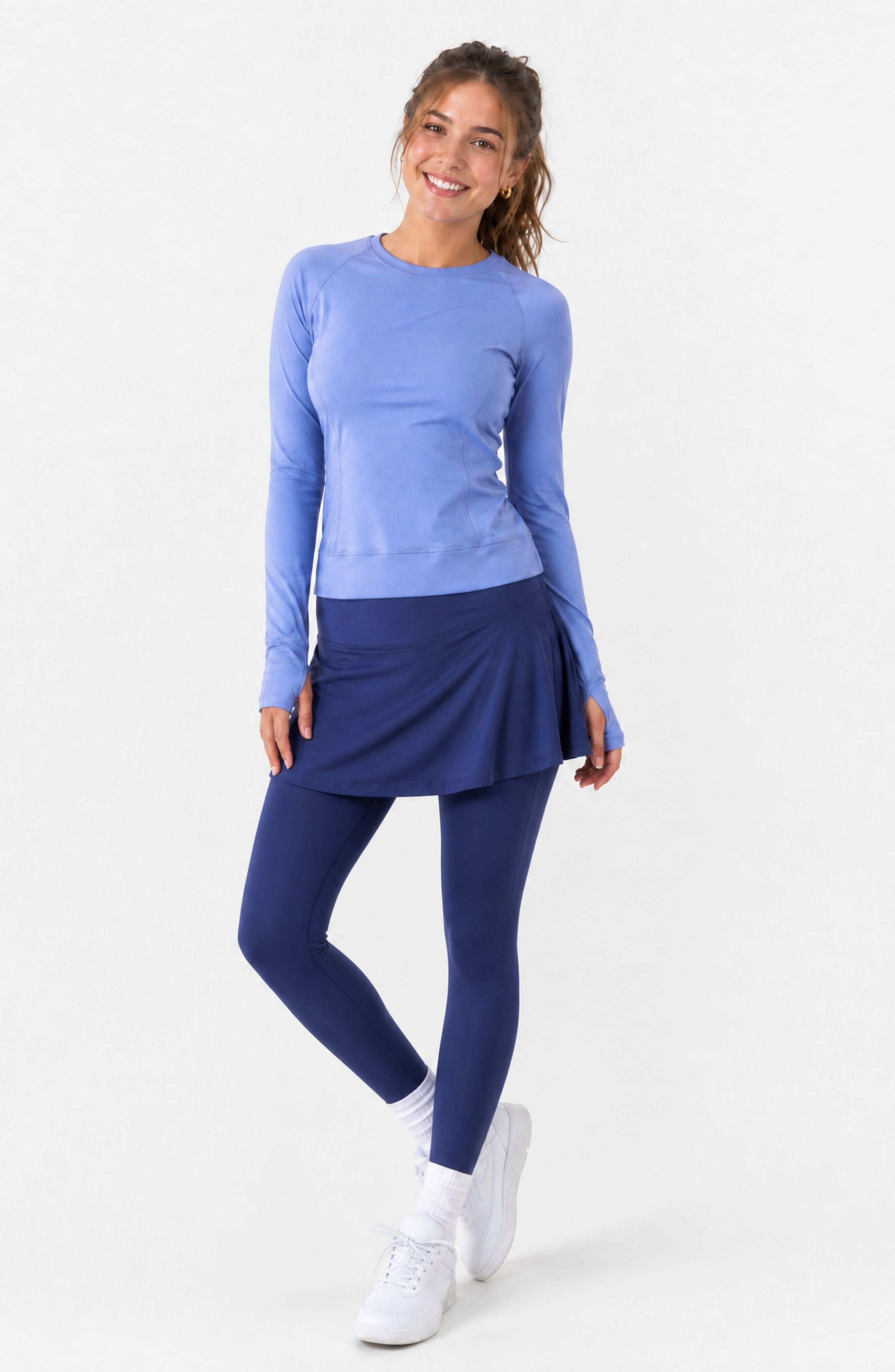 Woman wearing a blue athletic outfit on a white background