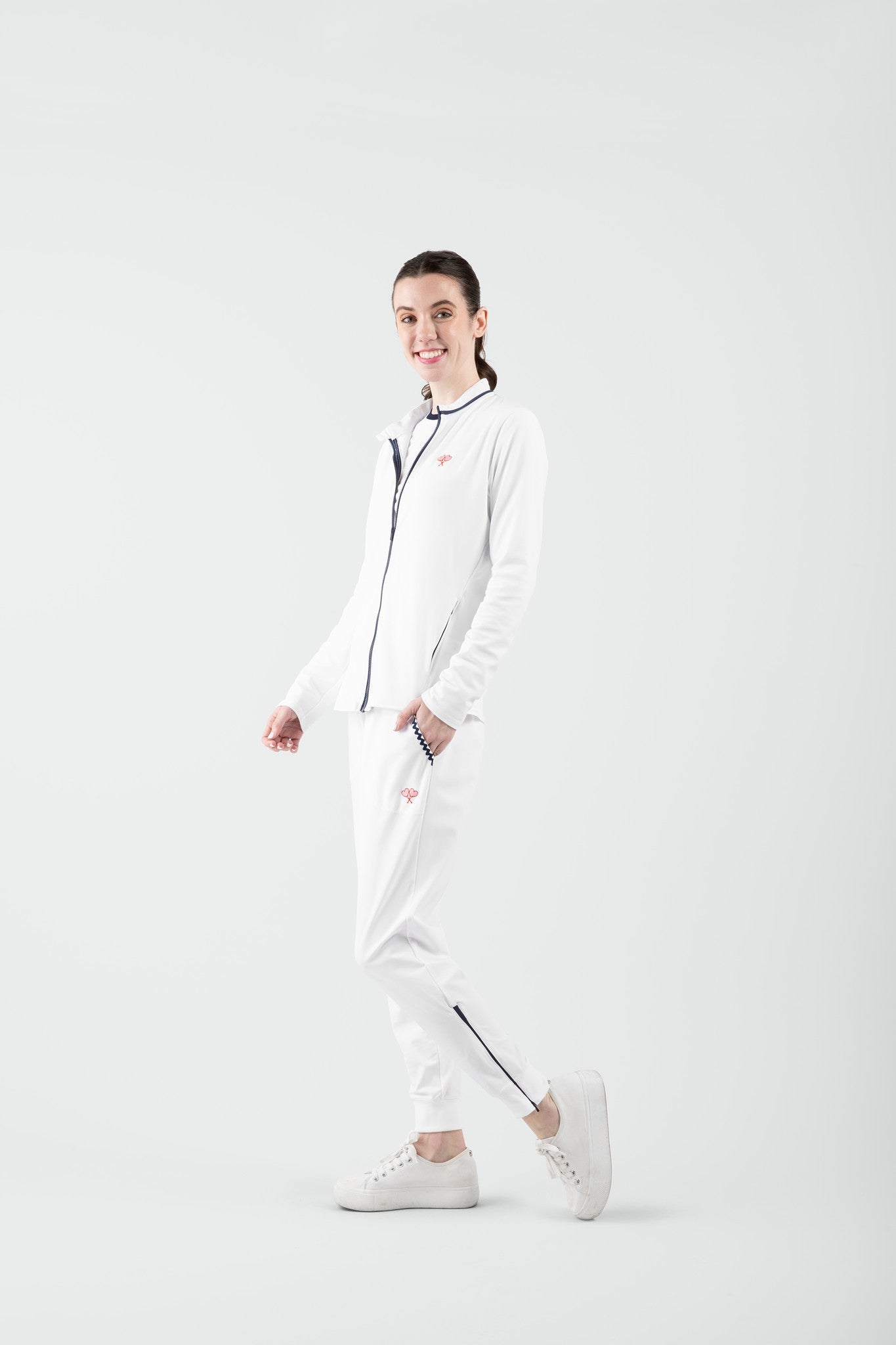 Person wearing a white pants on a plain background