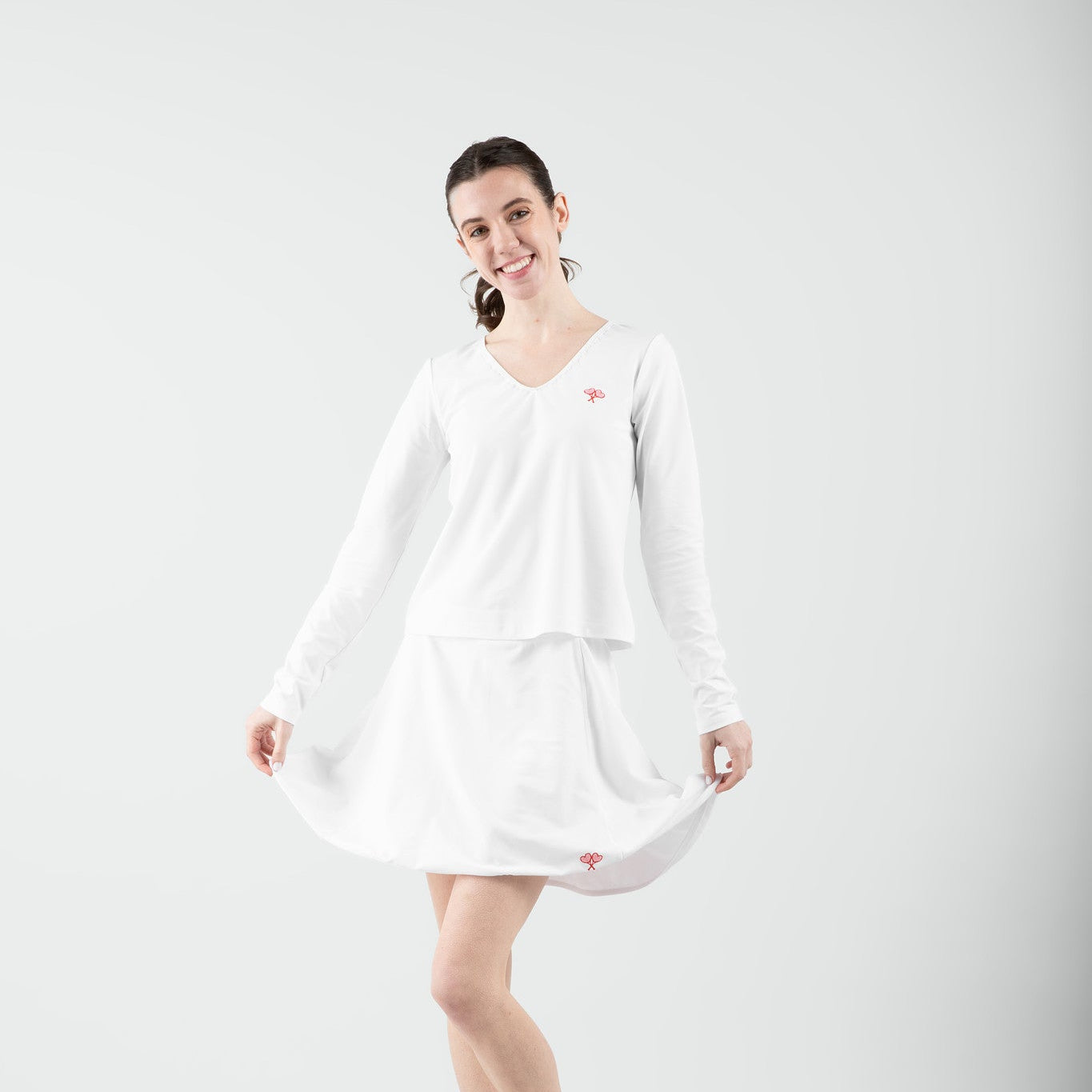 Woman wearing a white dress on a plain background