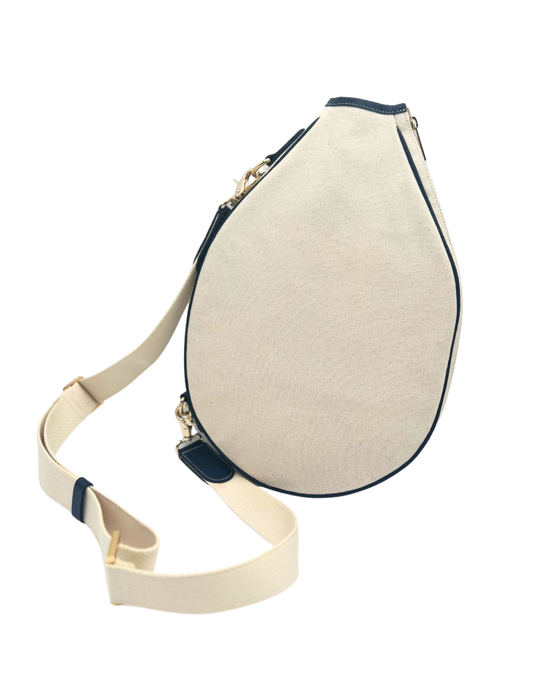 A cream-colored teardrop-shaped crossbody bag with dark navy blue trim and a matching cream adjustable shoulder strap, shown on a plain white background.