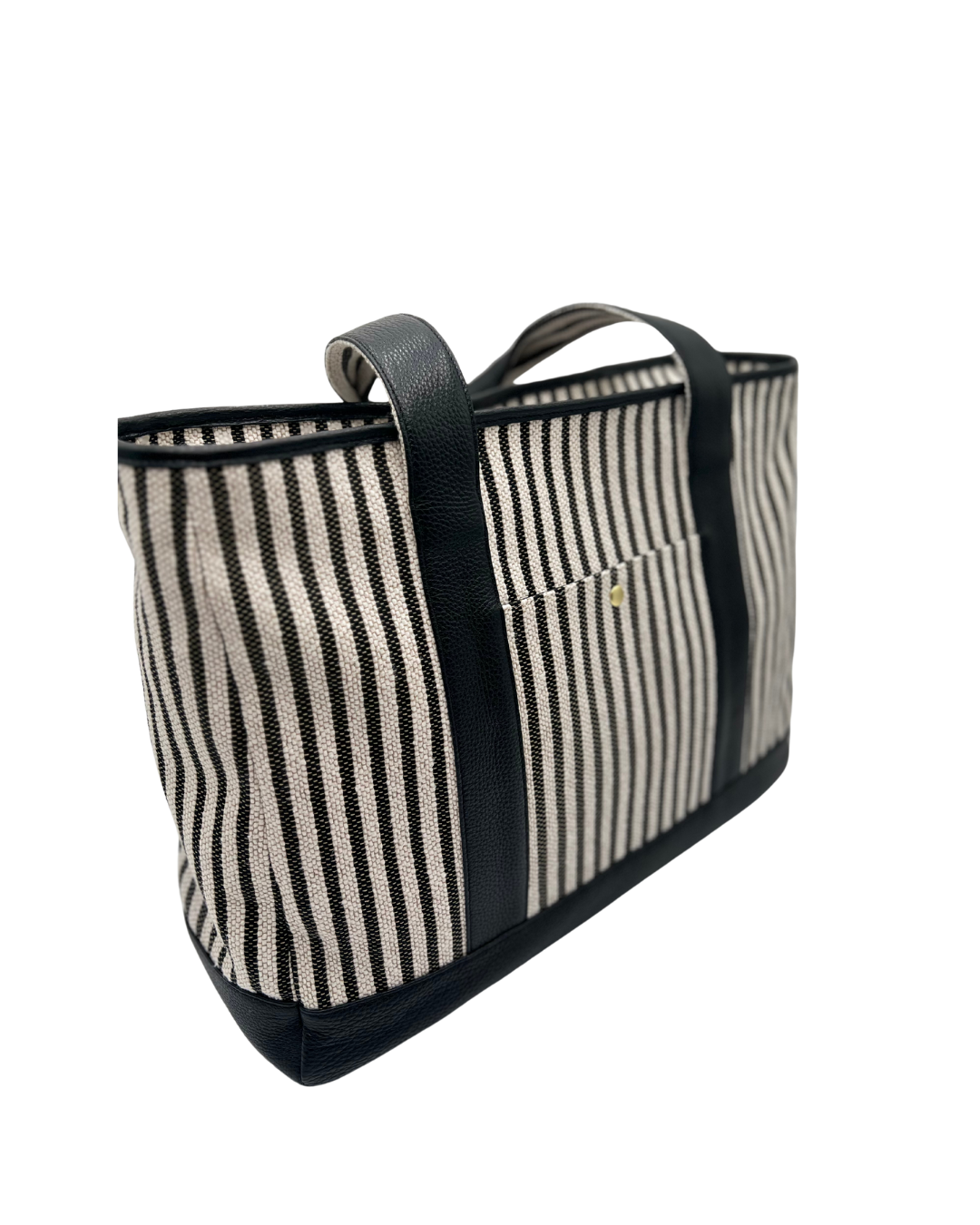 A striped tote bag with black leather trim, handles, and base, featuring vertical black and cream stripes on a woven canvas body.