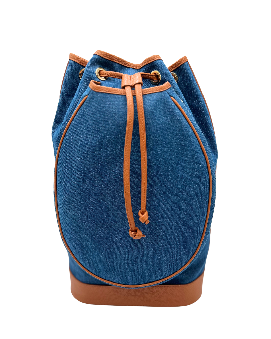 A blue denim bucket bag with tan leather trim, drawstring closure, and a tan leather base, shown against a plain white background.