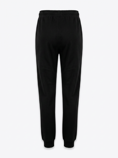 Black sweatpants with an elastic waistband and ribbed ankle cuffs, shown from the back on a light gray background.