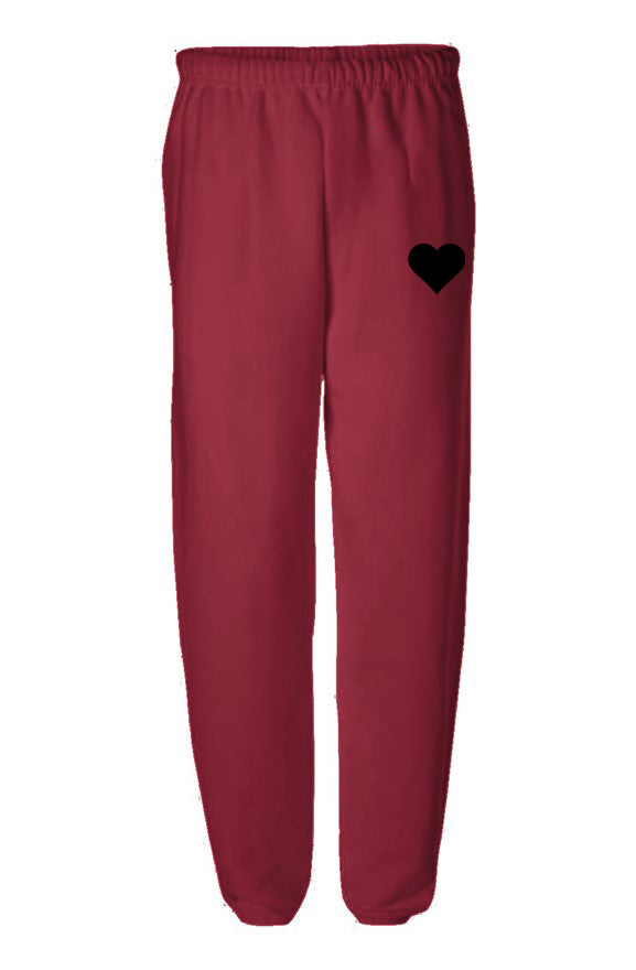 Red sweatpants with black heart logo on flat white background