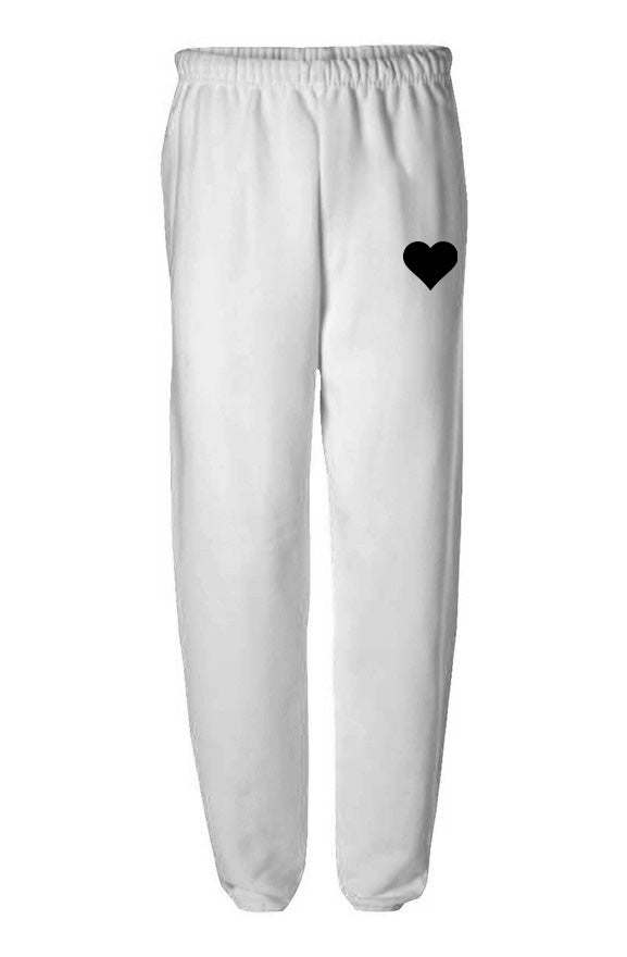White elastic waist sweatpants with black heart logo on flat white background