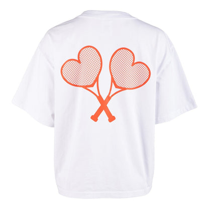 White t-shirt with red heart-shaped tennis rackets on a white background