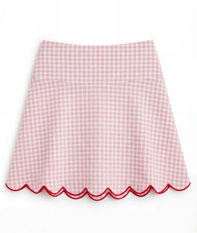Pink gingham skirt with scalloped edge on a white background