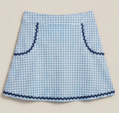 Blue and white checkered apron with navy trim on a beige background