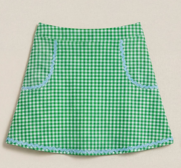 Green gingham skirt with blue trim on a beige background