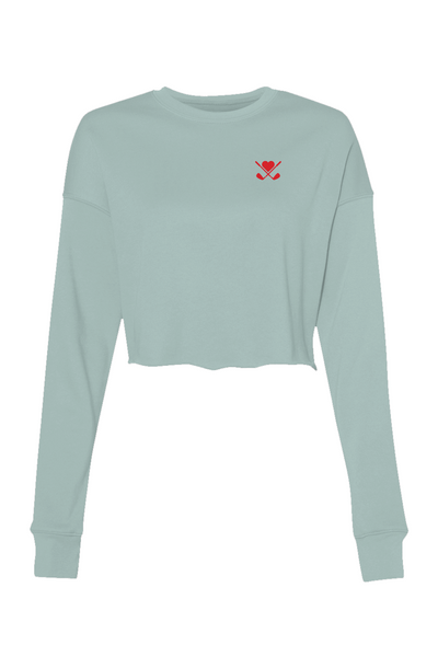 Light blue long-sleeve crop top with a red heart and cross design on a white background