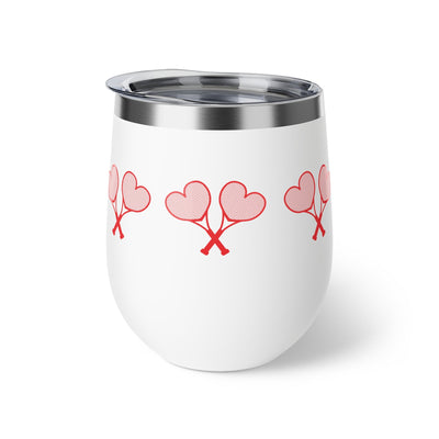 White tumbler with red heart designs on a white background