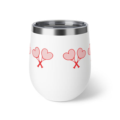 White tumbler with red heart designs on a white background