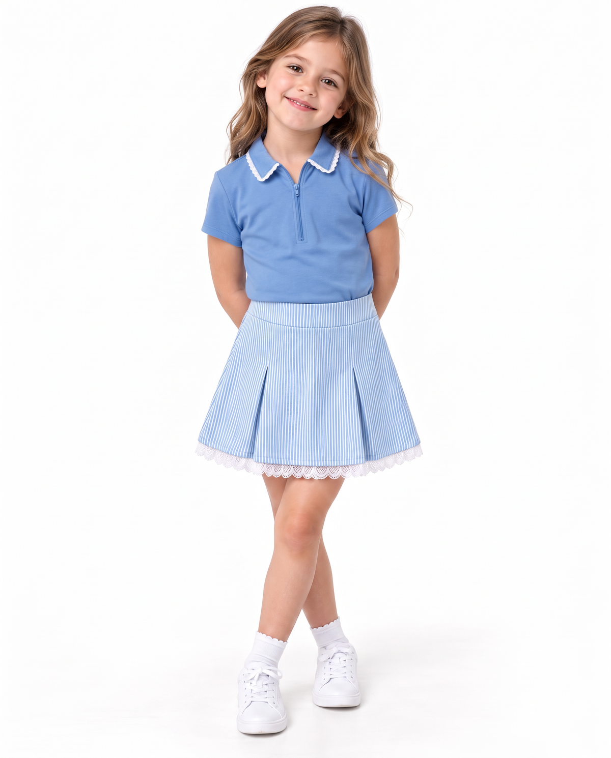 A young girl modeling a light blue polo shirt with a white collar and a matching light blue pleated skirt with white lace trim, paired with white socks and sneakers, on a solid white background.