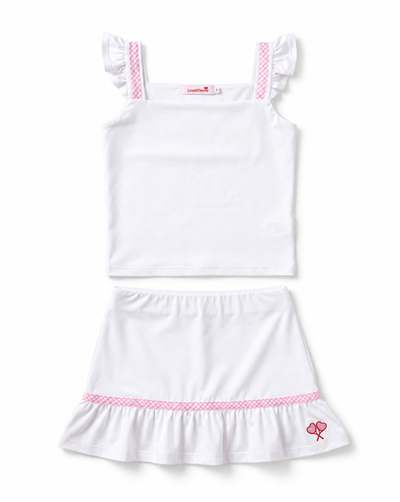 A two-piece children's outfit set consisting of a white sleeveless top with ruffled shoulder straps and a matching white ruffled skirt, both featuring pink patterned trim details.