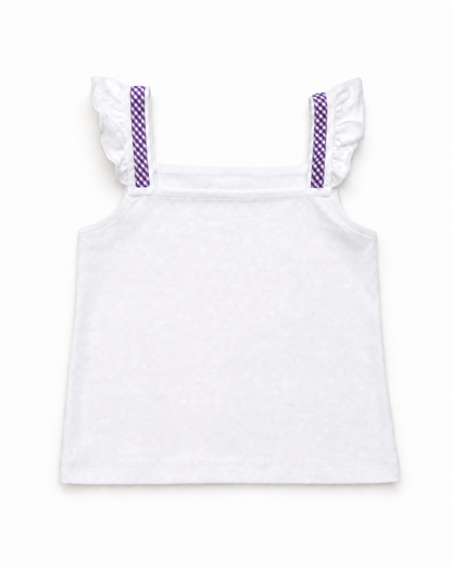 A white sleeveless children's top with ruffled shoulder straps and purple patterned strap details, shown flat against a white background.