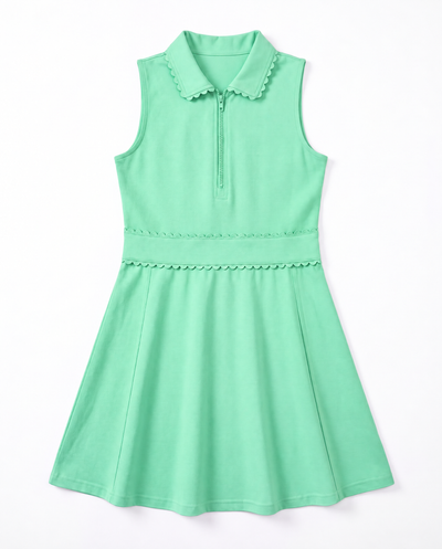 A mint green sleeveless dress with a half-zip collar, scalloped trim details, and a flared skirt, shown against a plain white background.