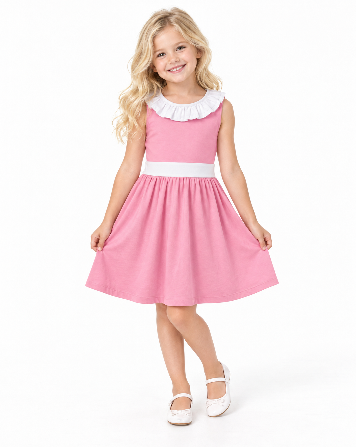 A young girl with blonde hair is wearing a pink sleeveless dress with a white ruffled collar and a white waistband, standing against a plain white background.