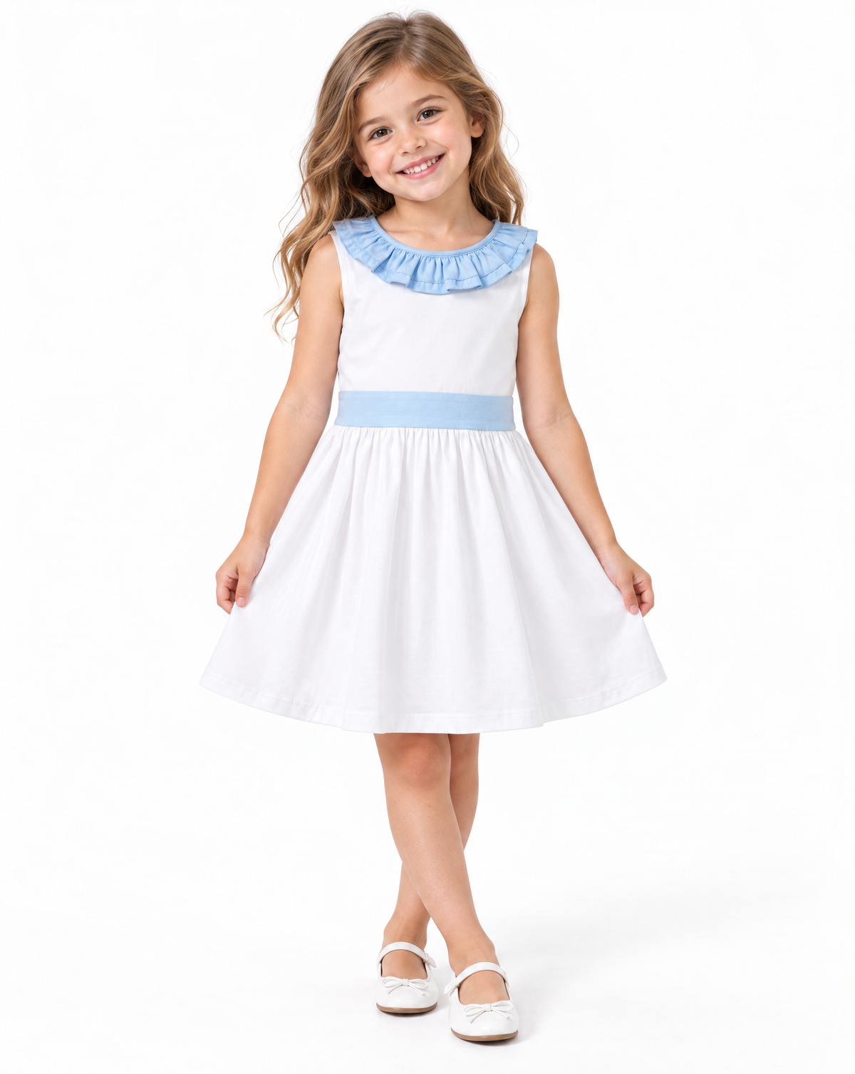 A young girl with blonde hair smiling and wearing a sleeveless white dress with a light blue ruffled collar, a matching light blue waistband, and white Mary Jane shoes, photographed against a solid white background.