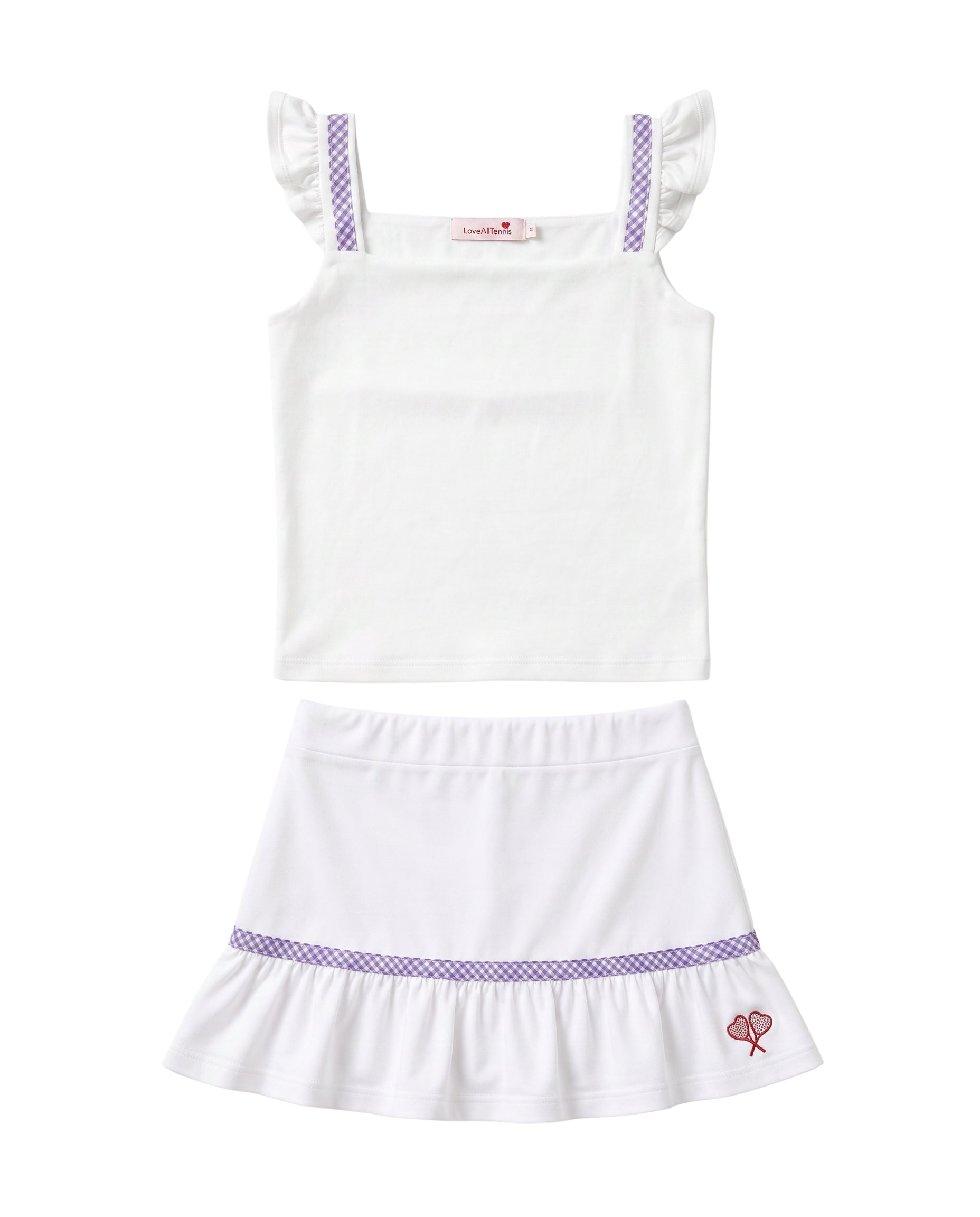 A two-piece girls' outfit set featuring a white sleeveless top with purple patterned shoulder straps and a matching white ruffled skirt with a purple patterned band and a small pink bow detail.