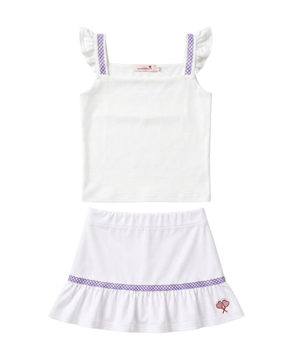 A two-piece girls' outfit set featuring a white sleeveless top with purple patterned shoulder straps and a matching white ruffled skirt with a purple patterned band and a small pink bow detail.