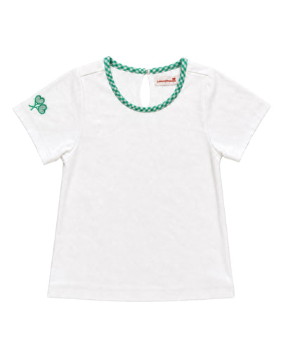 A white short-sleeve baby tee with a green and white checkered trim around the crew neck and a green shamrock on the left sleeve, shown on a plain white background.
