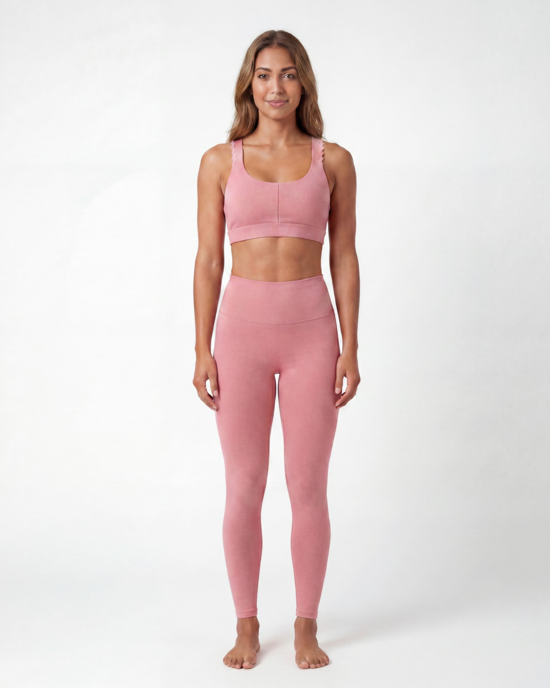 Woman wearing a pink athletic outfit on a white background