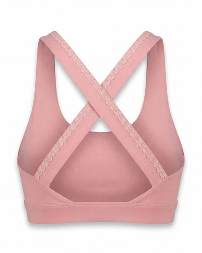 Pink sports bra with lace details on a white background