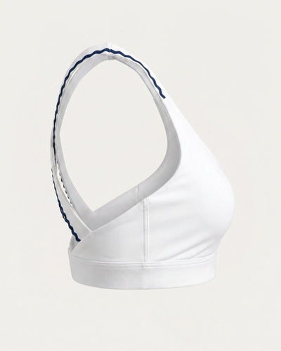 White sports bra with blue trim on a light gray background