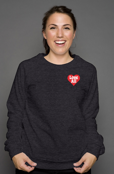 Person wearing a dark gray sweatshirt with a red heart design on a gray background