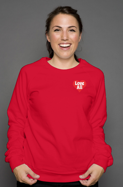 Person wearing a red sweatshirt with 'Love All' text on a gray background