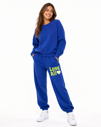 Woman wearing a blue tracksuit with 'Love All' text on a white background