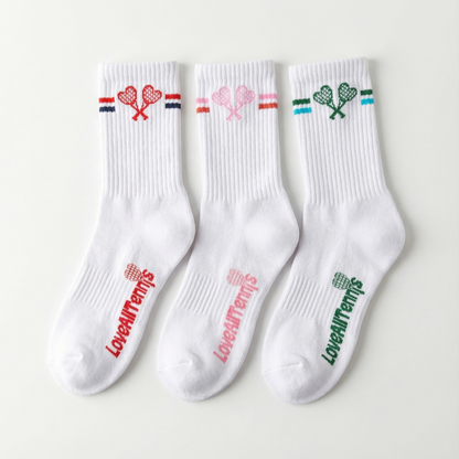Three white socks with colorful designs and text on a light gray background