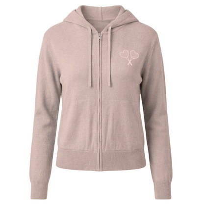 Pink hoodie with a logo on the chest against a white background