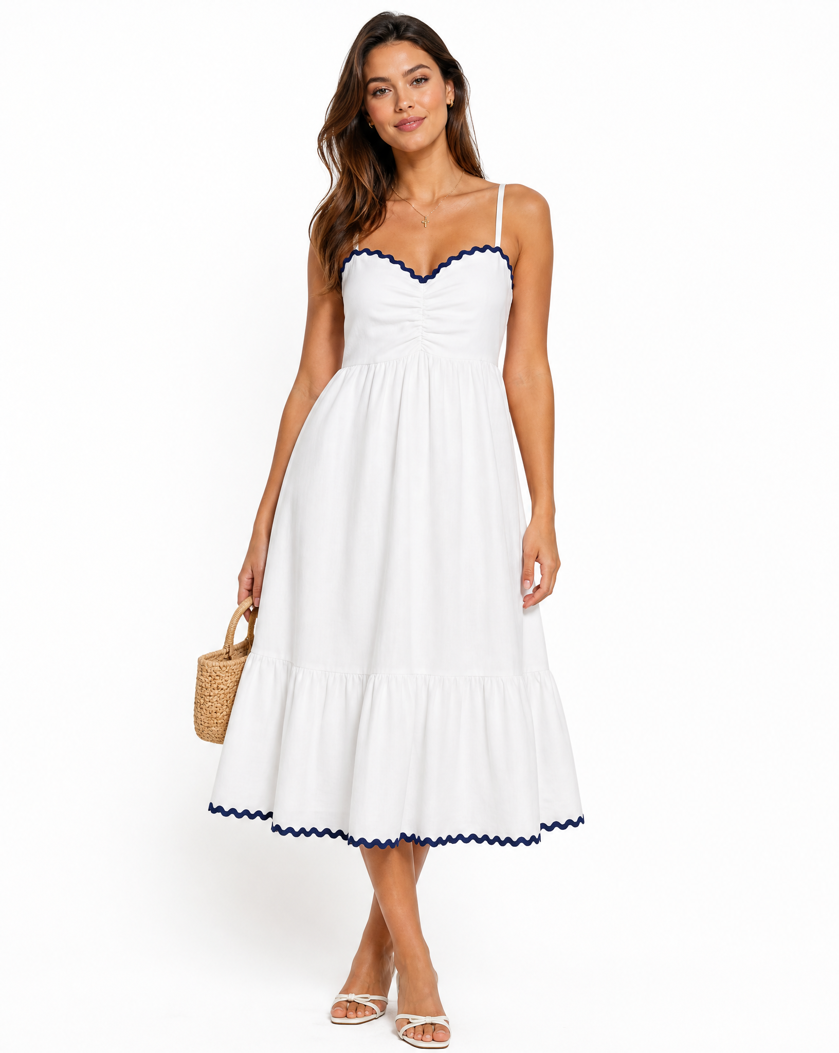 Woman wearing a white dress with blue trim on a white background