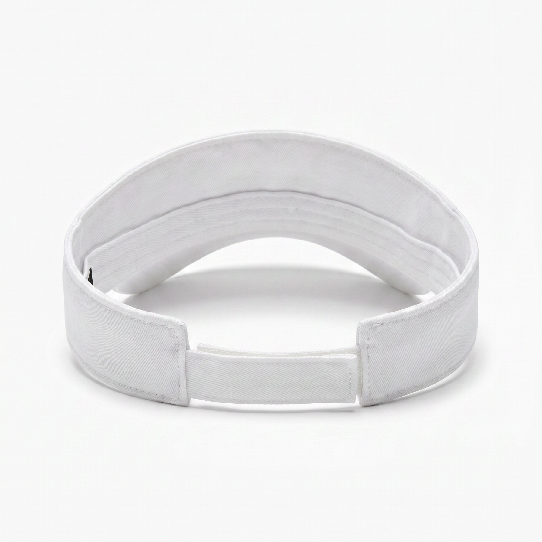 A white fabric visor with an adjustable hook-and-loop closure, photographed on a seamless white background.