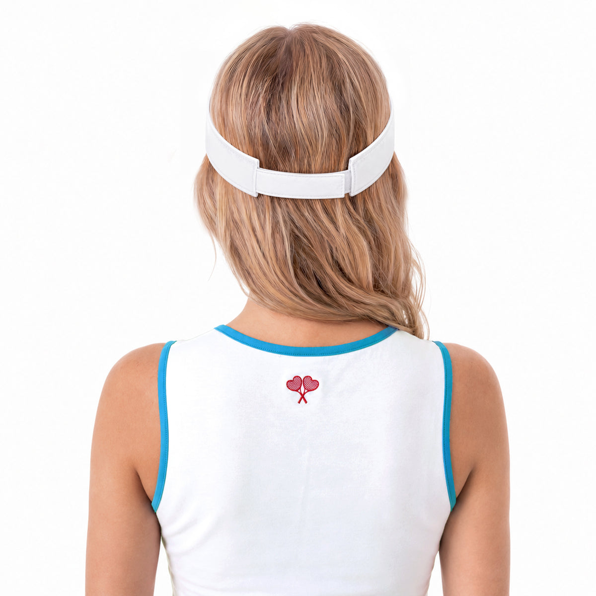 A woman viewed from behind wearing a white visor-style headband and a white sleeveless top with blue trim and a small red heart graphic on the back, against a plain white background.
