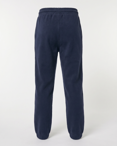 A pair of navy blue sweatpants shown from the back, featuring an elastic waistband and ribbed ankle cuffs, photographed against a light gray studio background.