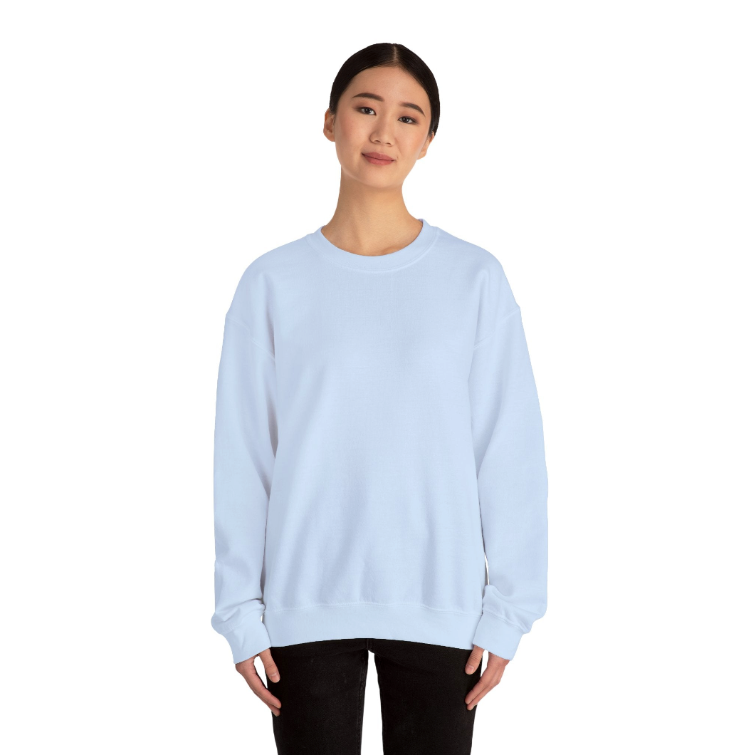 Woman wearing a light blue sweatshirt and black pants set against a white background