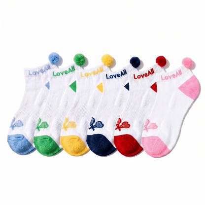 Set of six colorful socks with pom-poms on a white background