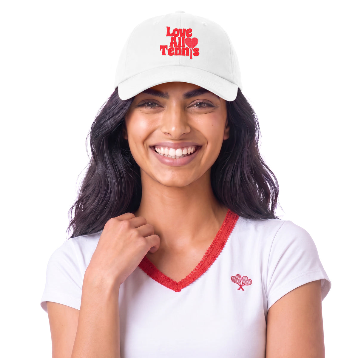 A smiling woman wearing a white baseball cap with red embroidered text reading 'Love All Tennis' and a matching white V-neck T-shirt with red trim and a small red tennis racket logo, against a plain white background.