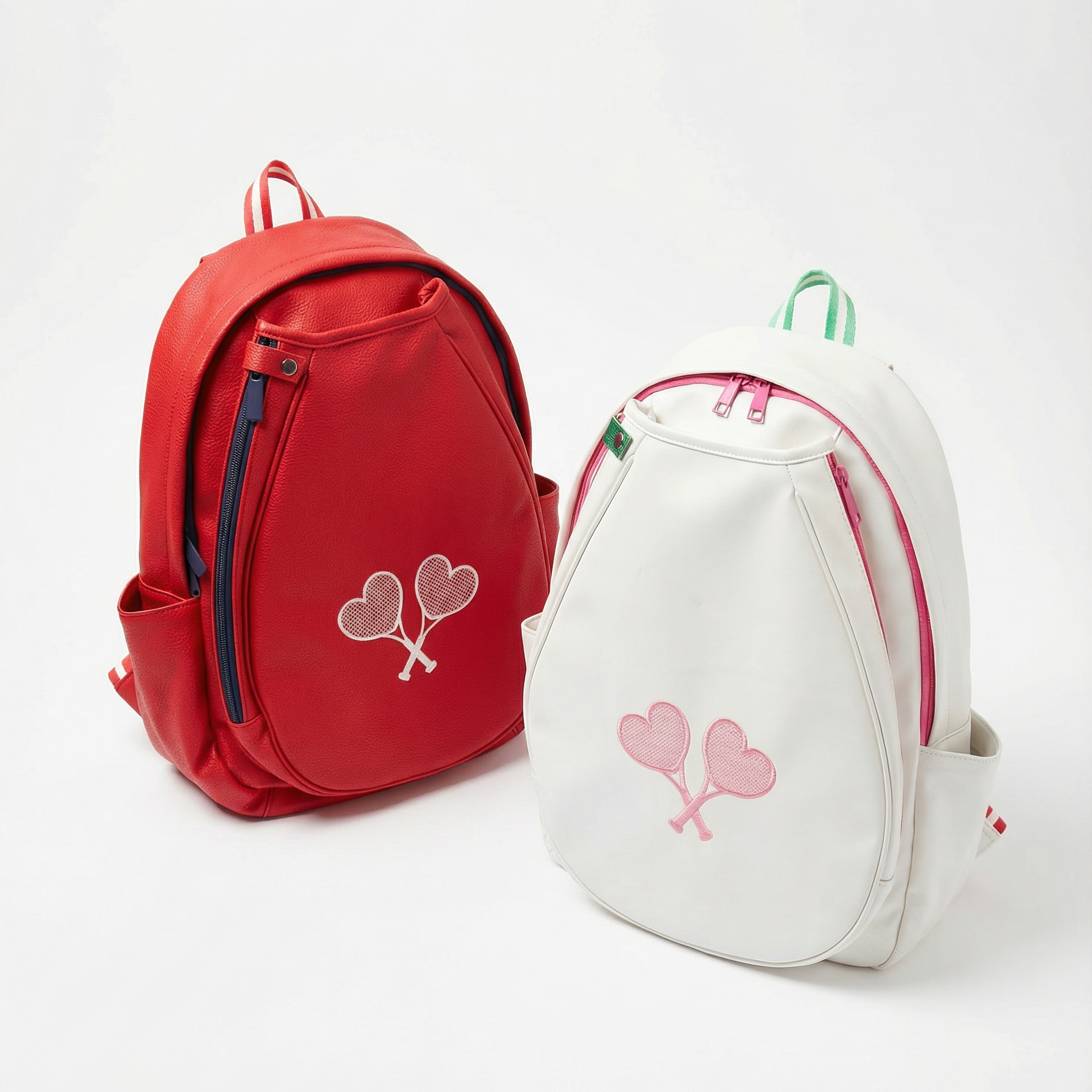 Red and white backpacks with heart designs on a white background