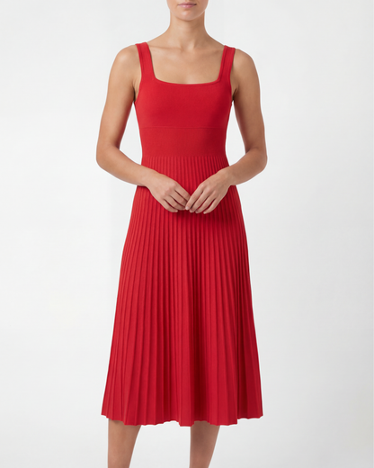 Red pleated dress worn by a model on a white background