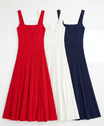 Three pleated dresses in red, white, and navy on a white background
